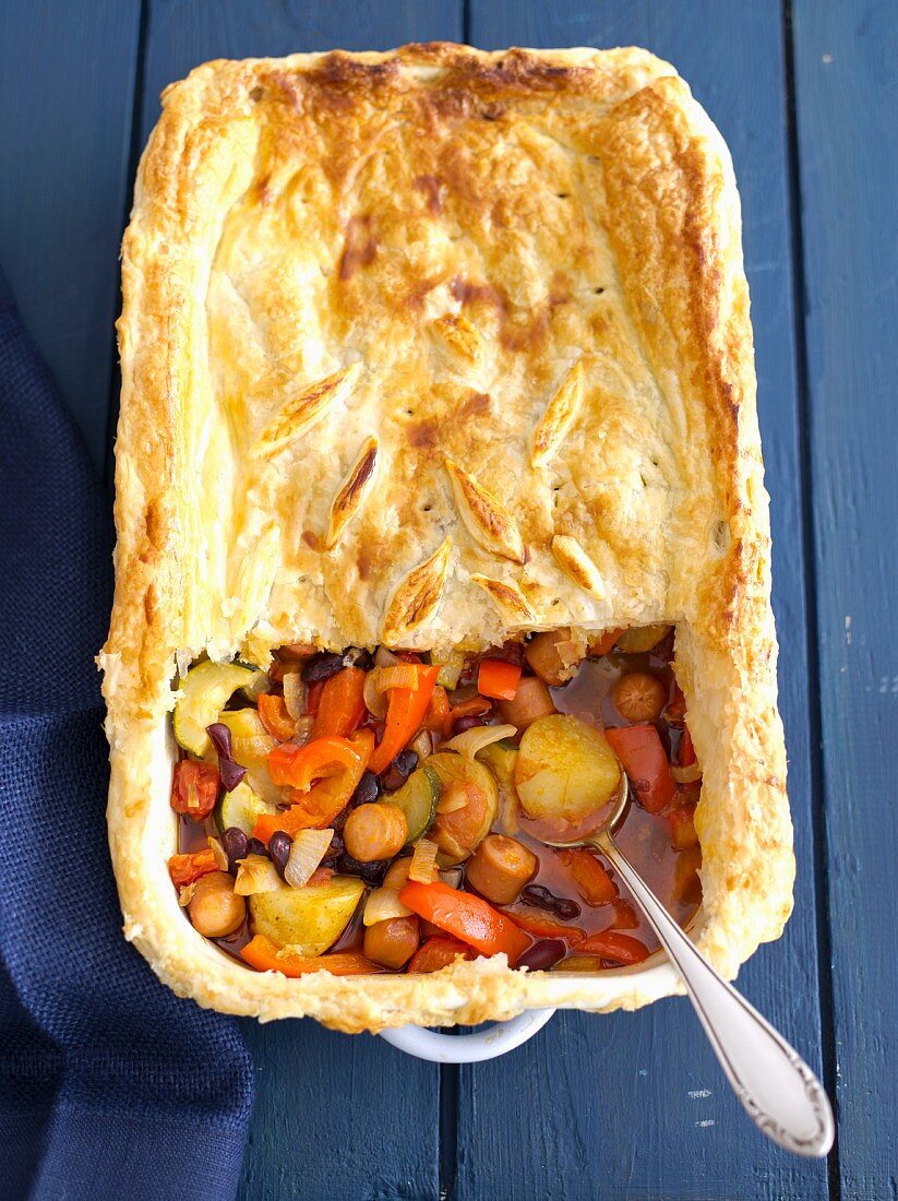 Sausage and vegetable bake with kidney beans and a puff pastry topping