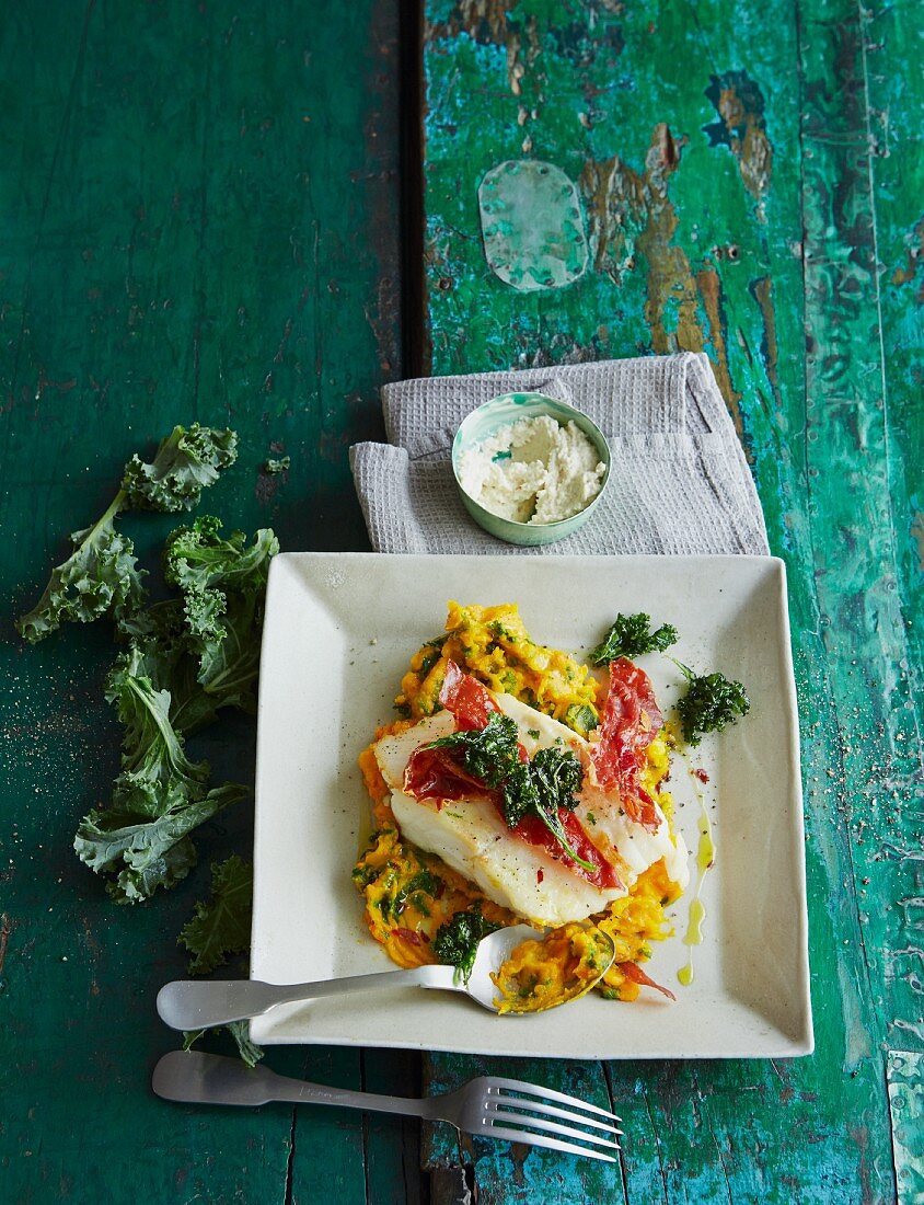 Green kale and pumpkin mash with cod and horseradish sour cream