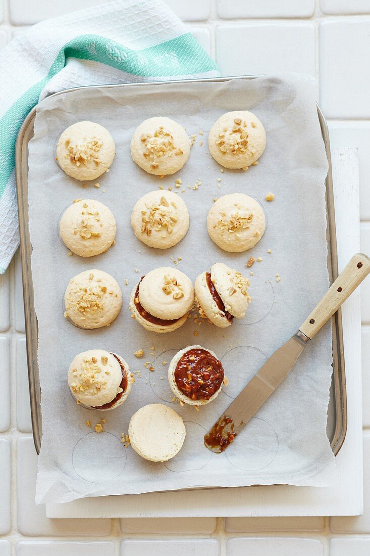 Macaroons with a peanut and chocolate filling and chopped peanuts