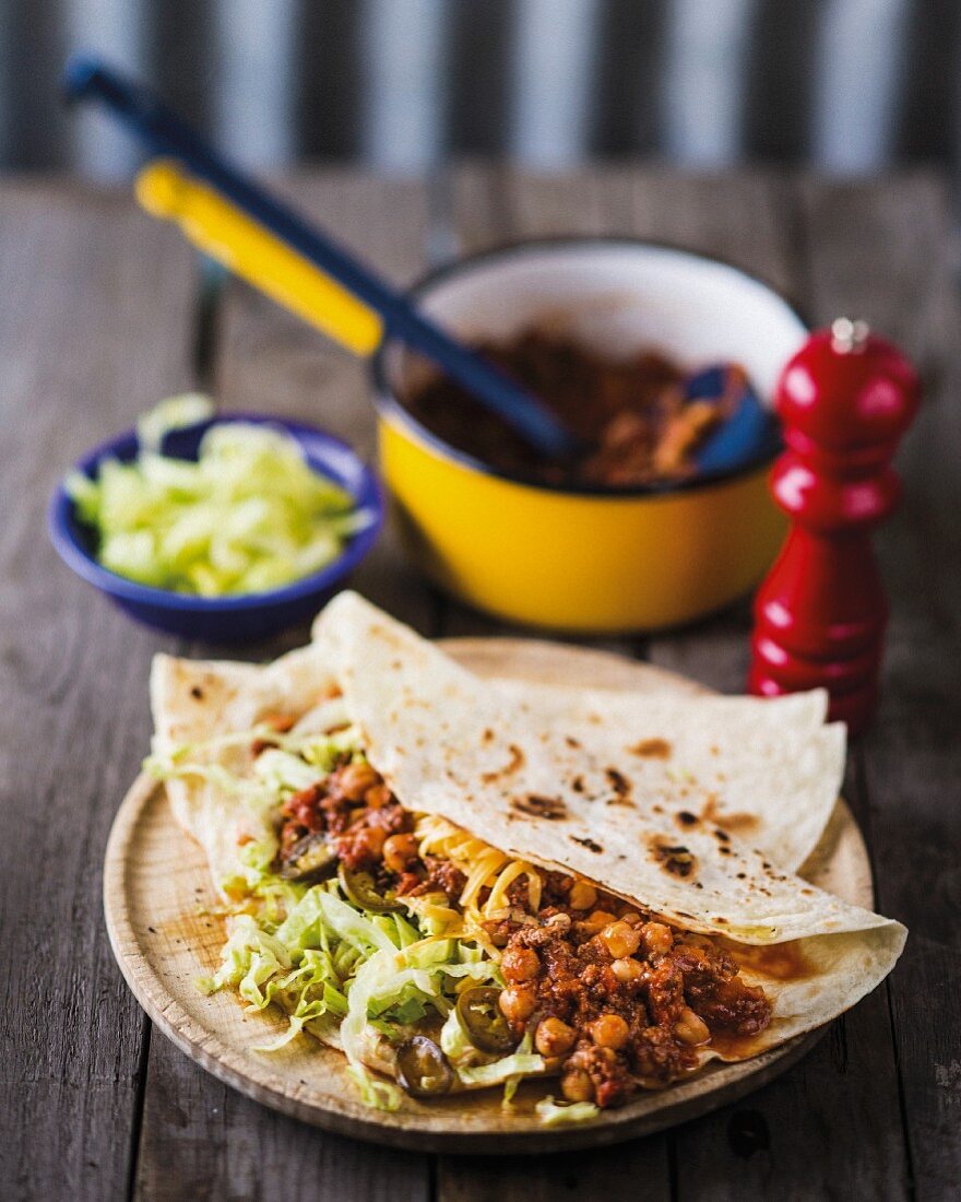 Wraps filled with chickpeas, sloppy Joe sauce and iceberg lettuce