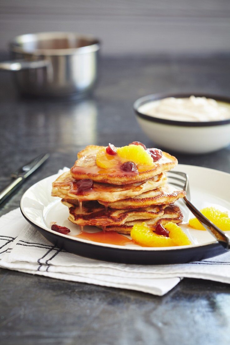 Gestapelte Pancakes mit Orangen und Cranberries
