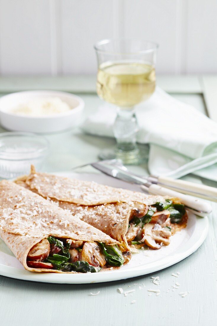 Two savoury crepes filled with mushrooms and spinach