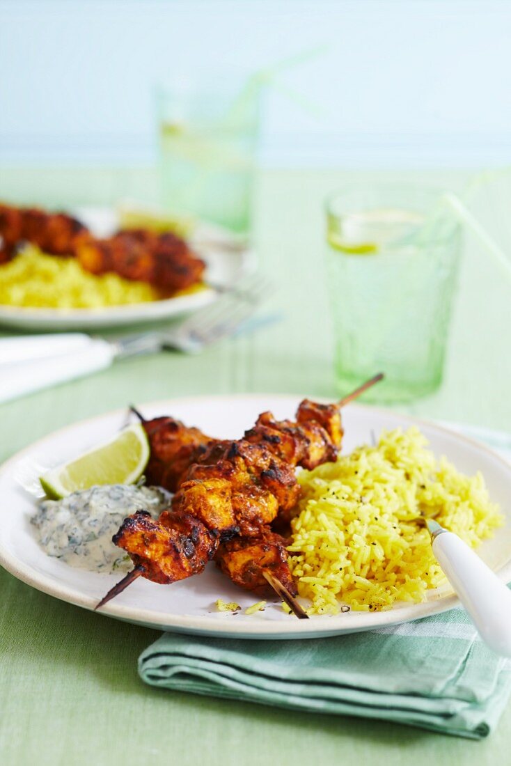 Curried chicken scewers with pilau rice and raita