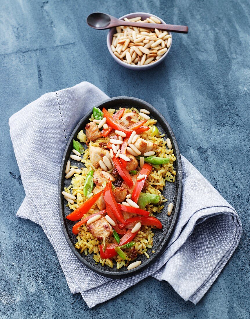 Rice with chicken, peppers, spring onions and pine nuts