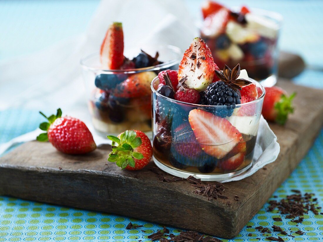 Berries in syrup with star anise and chocolate curls