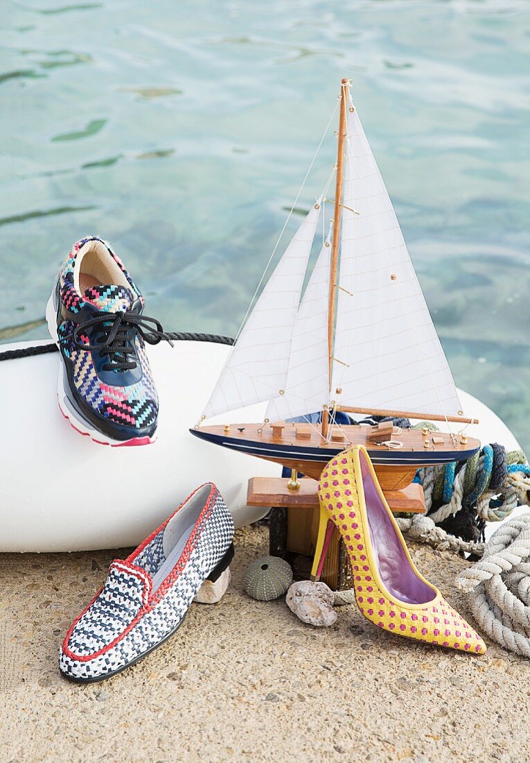 Various different types of colourful shoes with maritime decorations