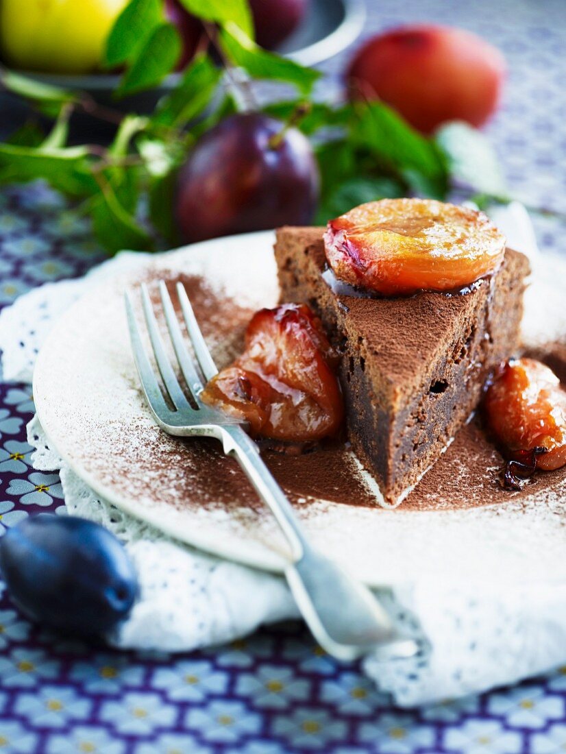 A slice of chocolate cake with roasted plums