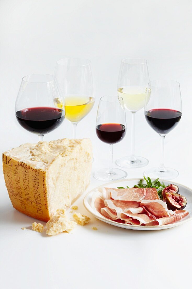 Various glasses of wine, Parma ham, figs and cheese