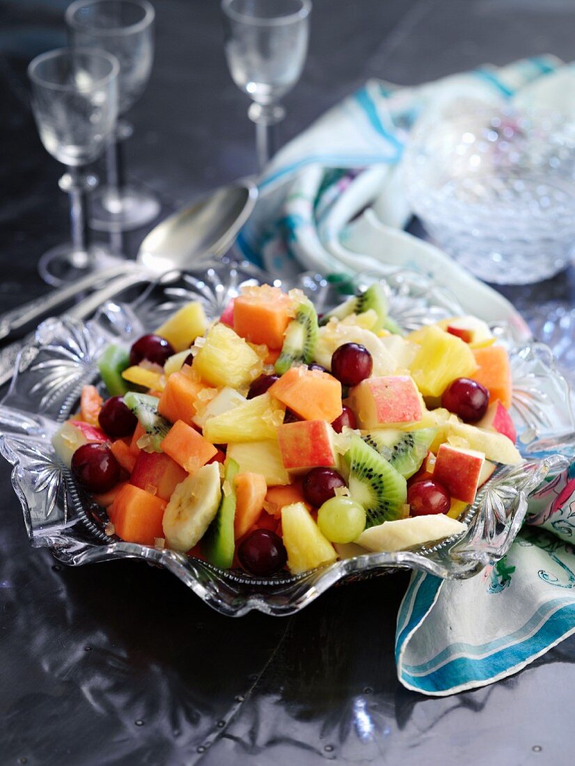 A mixed fruit salad in a crystal bowl