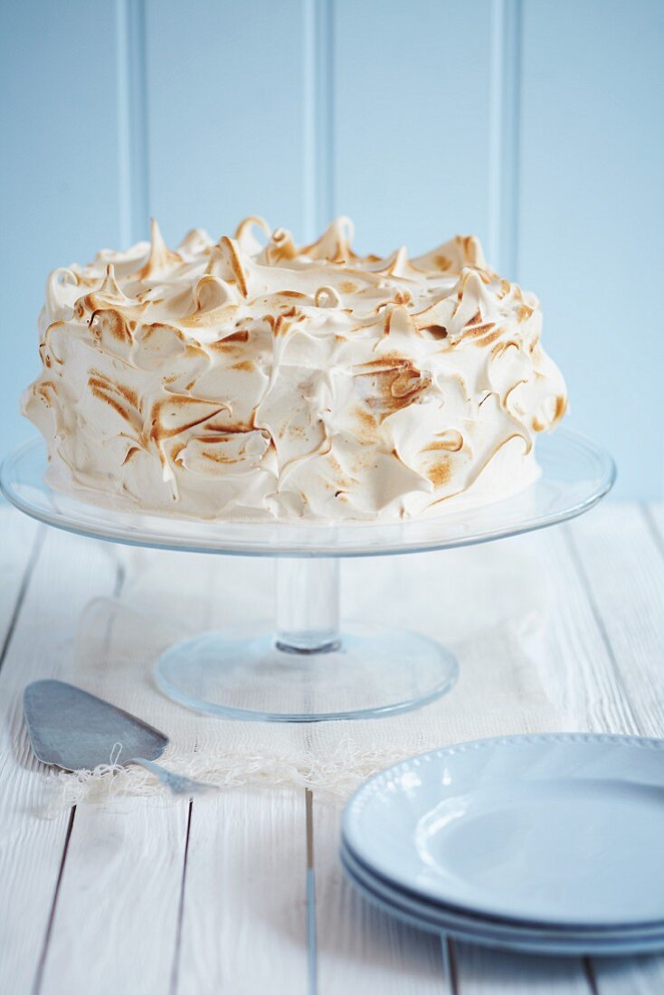 A celebration cake topped with meringue