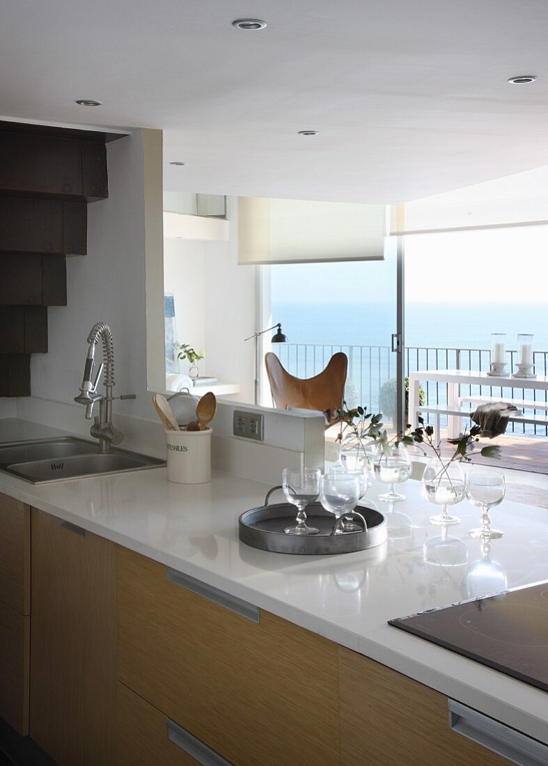 Kitchen counter below mezzanine level and balcony with sea view in background