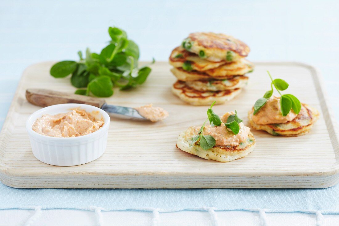 Blinis topped with trout and crab pâté and pea shoots