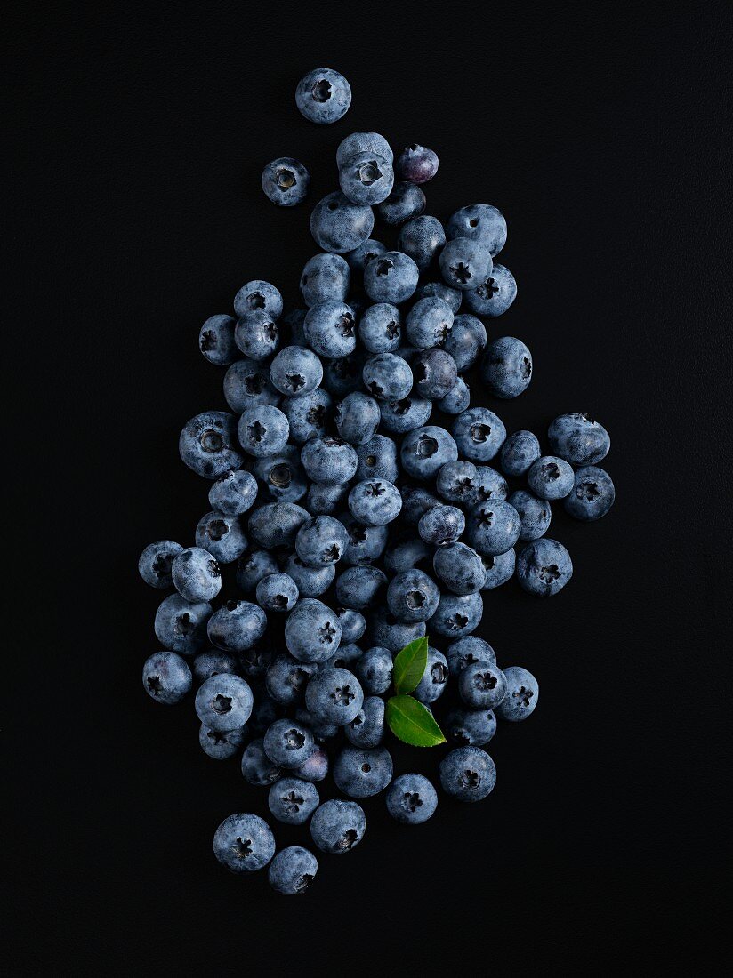 Fresh blueberries on a black surface