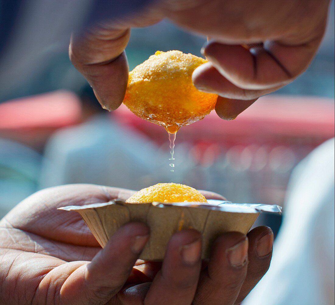 Hands holding freshly made panipuri (India)