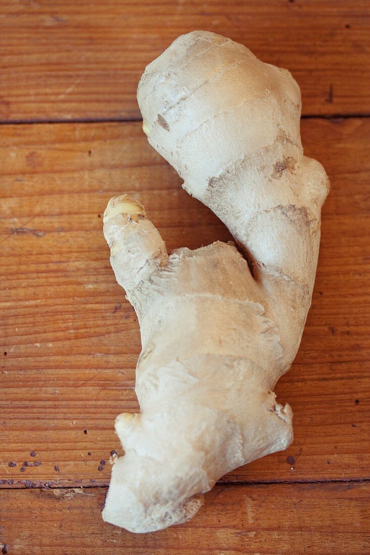 Fresh root ginger on a wooden surface