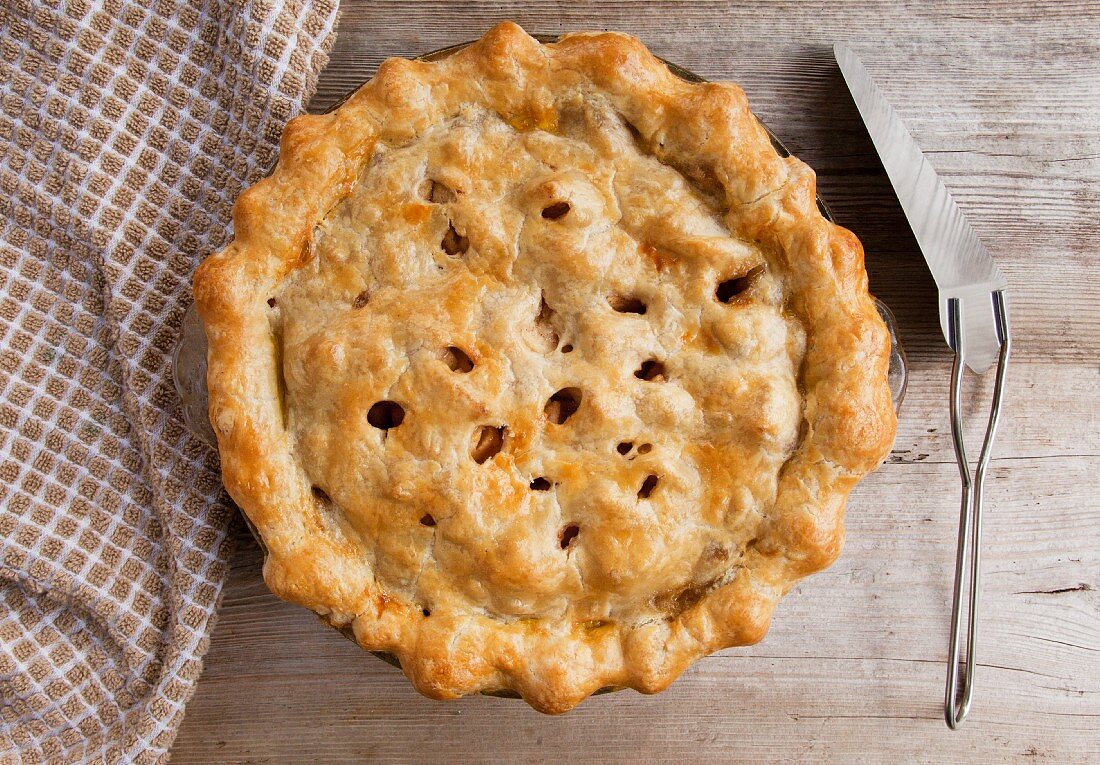 A homemade apple pie on a wood surface