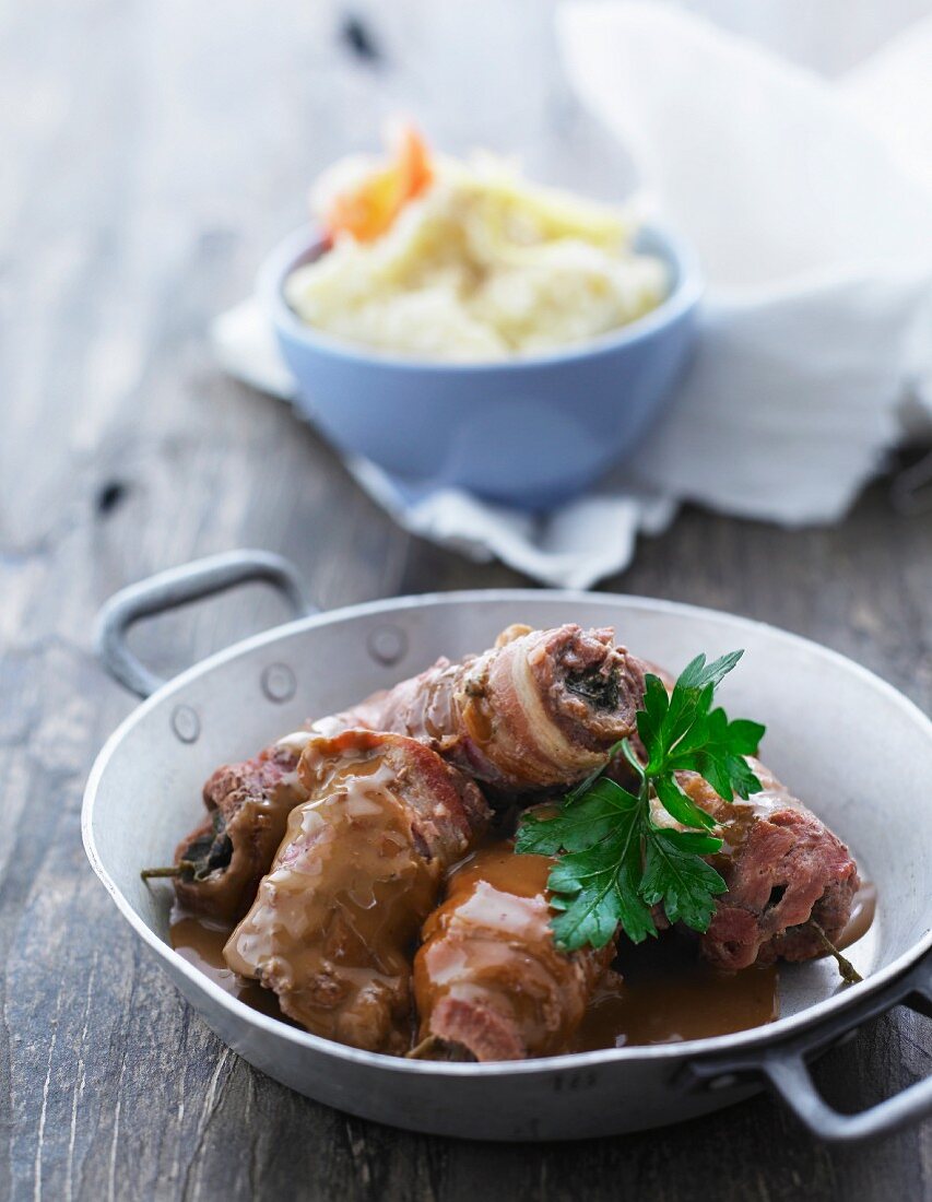 beef roulade wrapped in bacon served with mashed potatoes