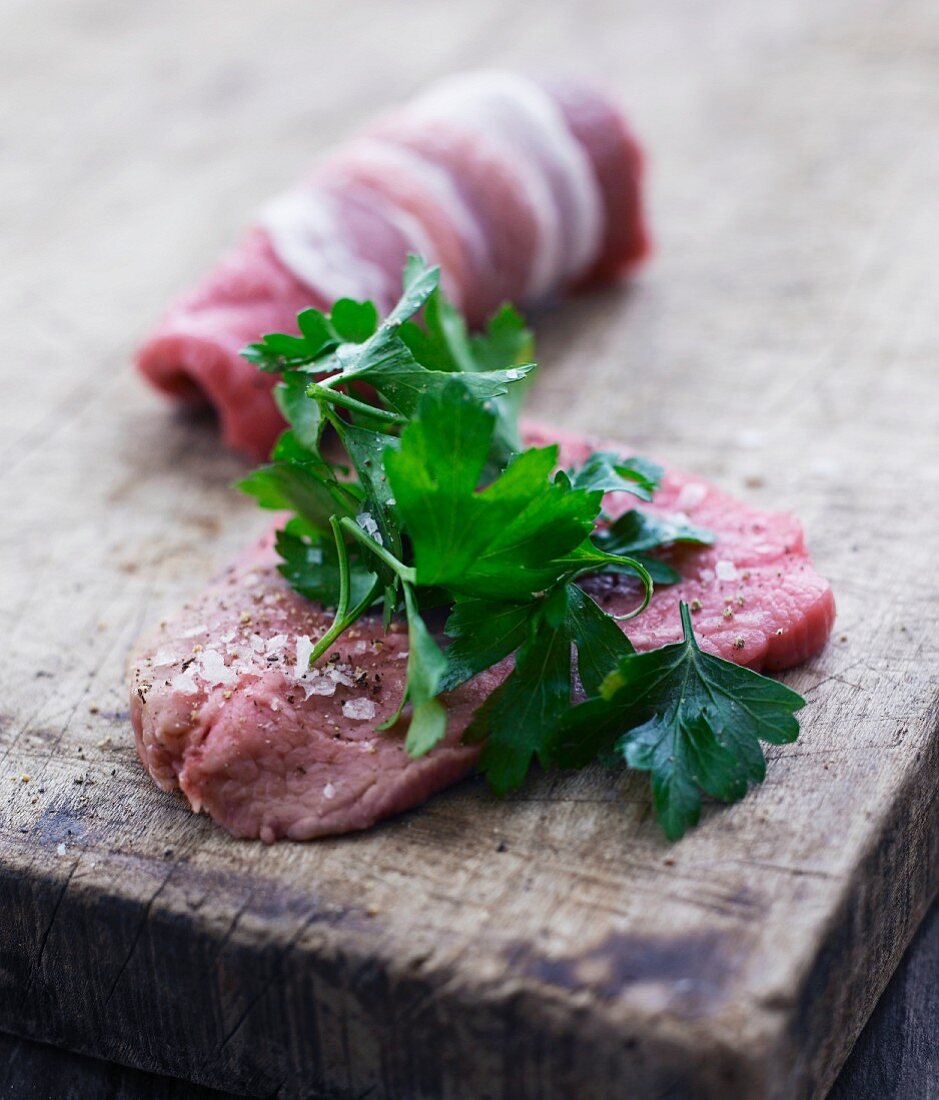 Beef roulade with bacon and parsley being made