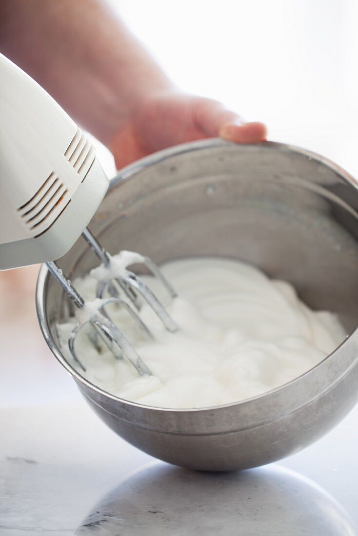 Egg whites being beaten with an electric whisk