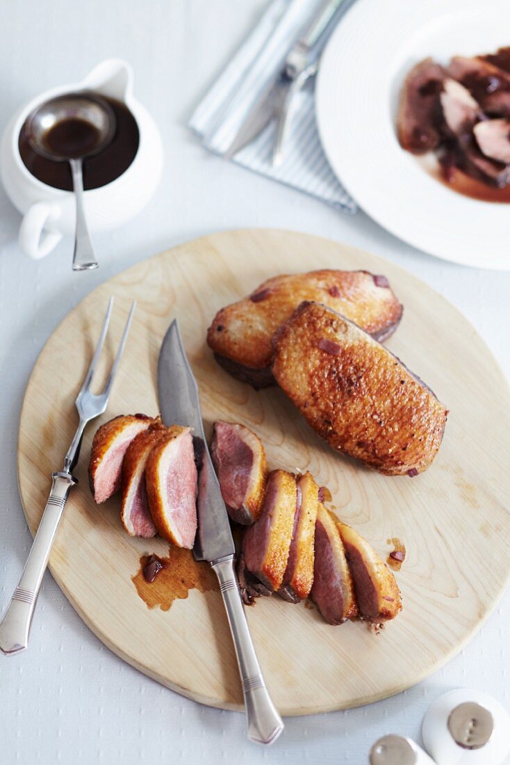 Medium rare roast duck breast with red wine gravy
