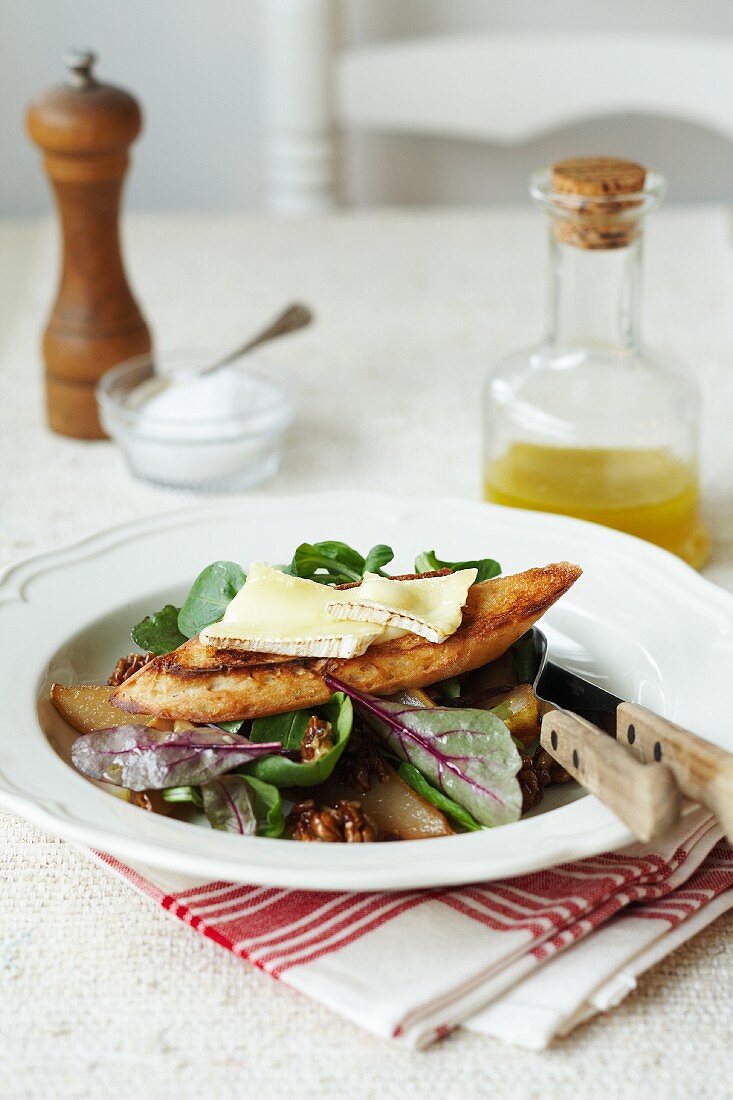 Walnut and pear salad with grilled bread topped with melted cheese