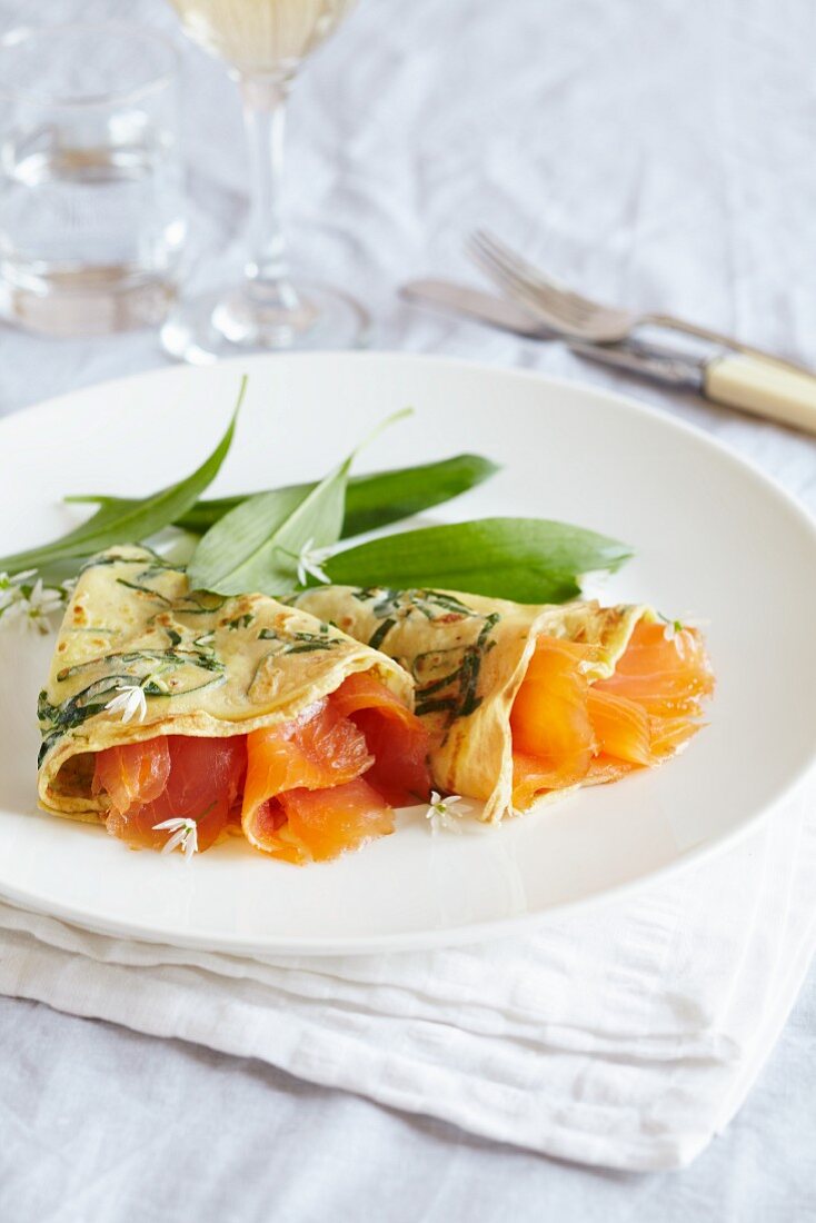 Spinach pancakes filled with smoked salmon and wild garlic
