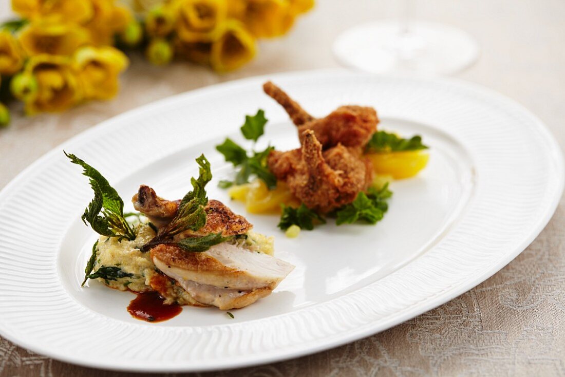 A duo of spring chickens on a bed of stinging nettle polenta and a potato and watercress salad