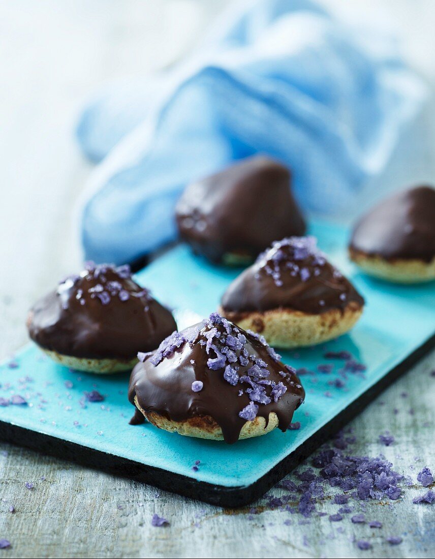 Almond macaroons with chocolate glaze and candied lavender