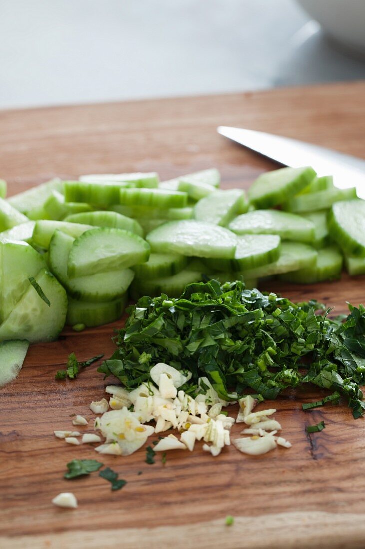 Sliced cucumber, fresh parsley and garlic for a salad
