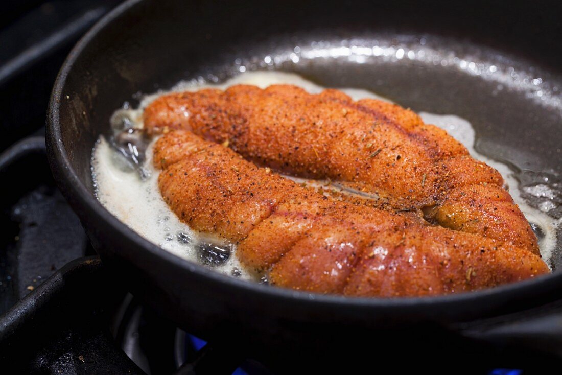 Spiced allis shad roe being fried in butter