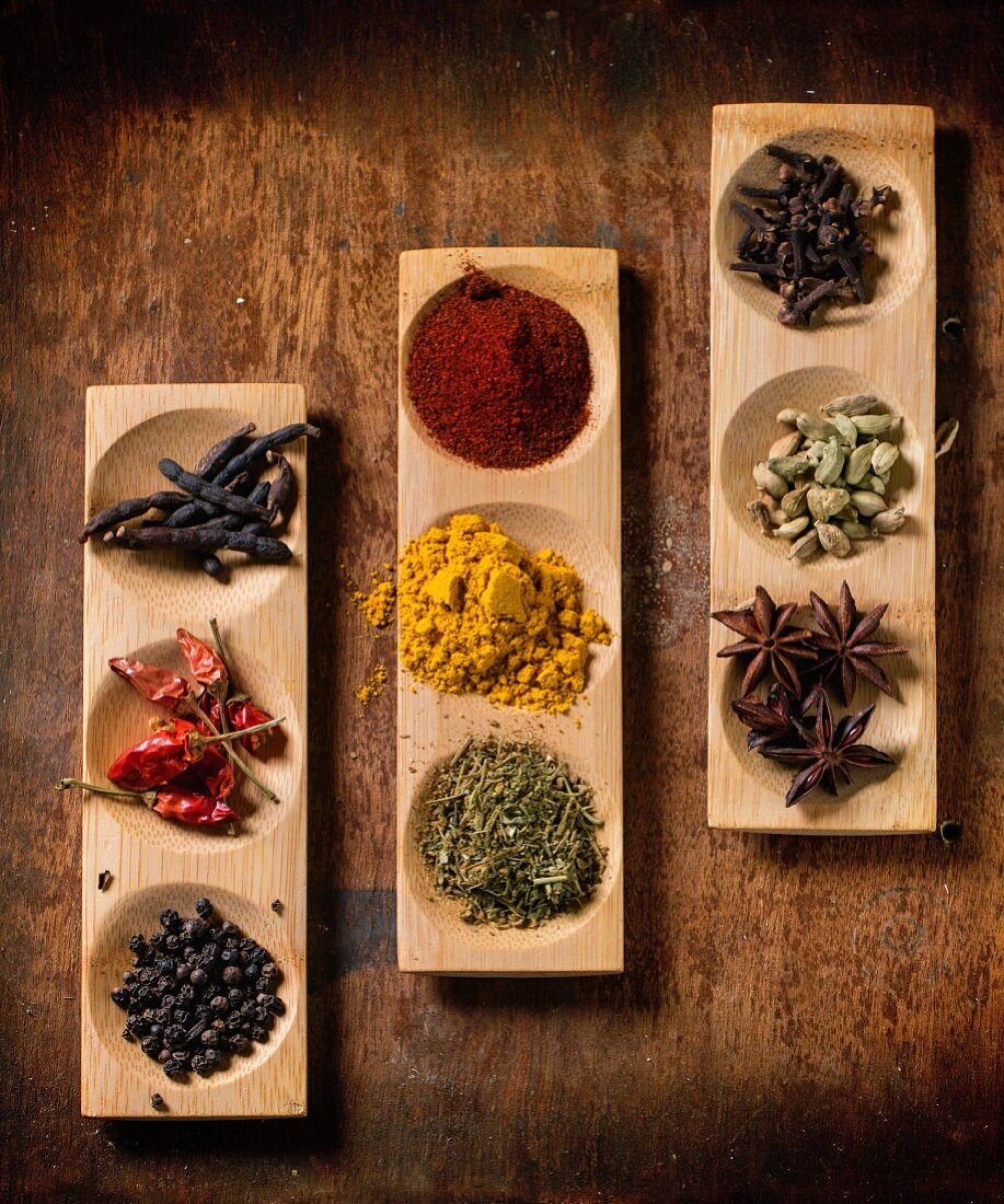 Various spices in wooden dishes (seen from above)
