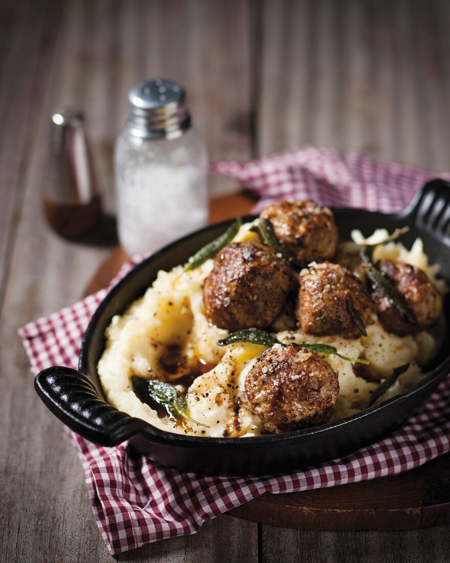 Meatballs on mashed potatoes with sage