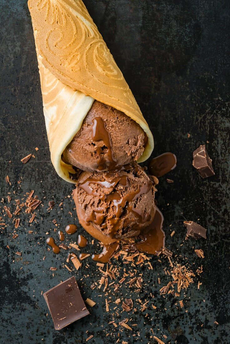 Chocolate ice cream with chocolate sauce in a homemade ice cream cone