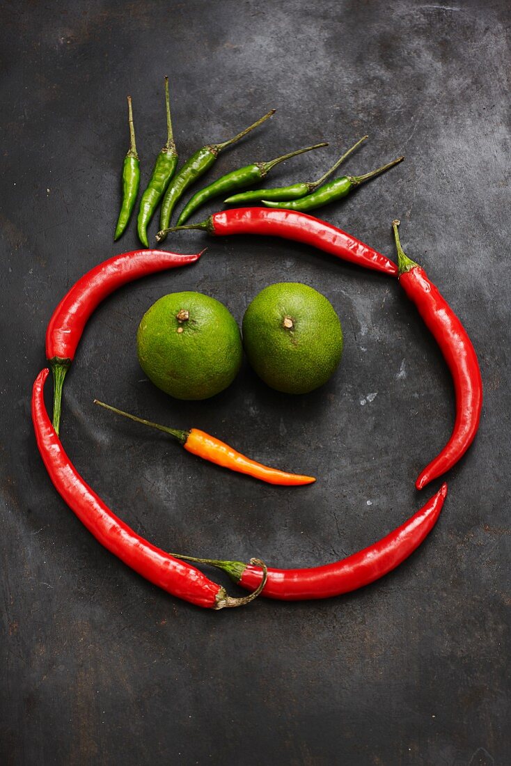 Chilli peppers and limes making a funny face
