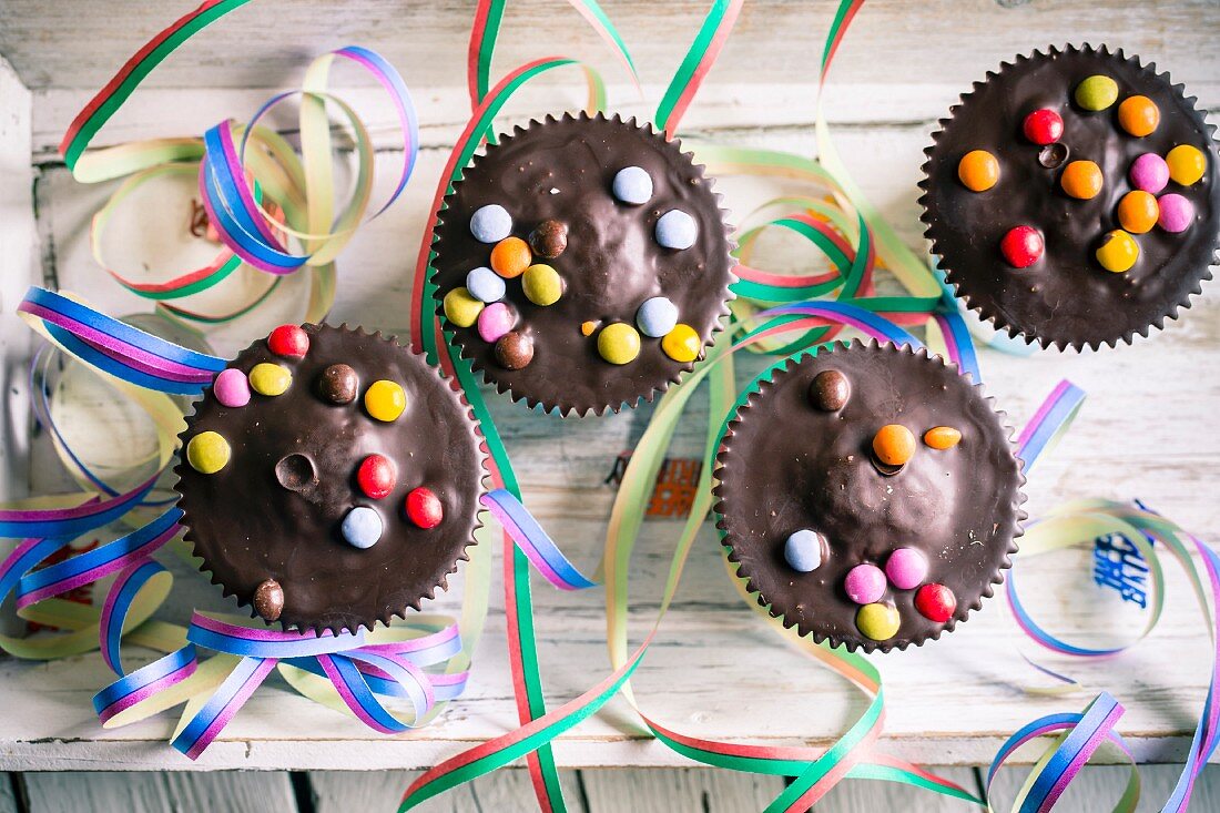 Muffins with chocolate glaze and colourful chocolate beans