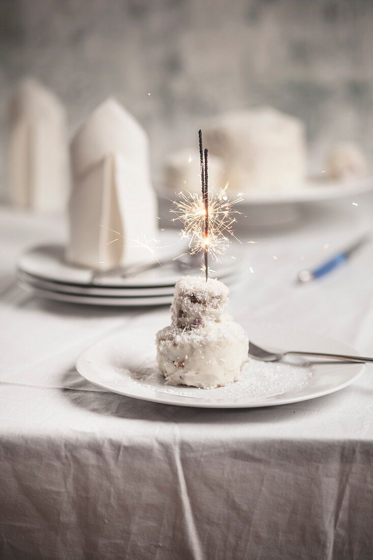 A coconut cake with a sparkler