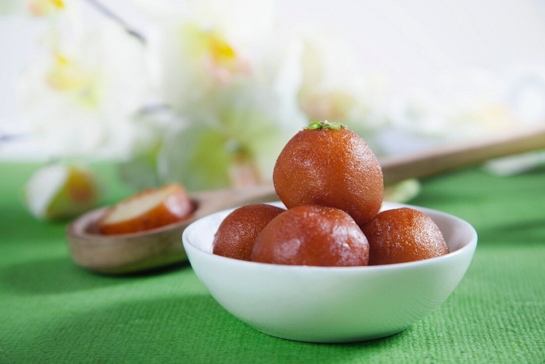 Gulab jamun in a bowl (deep-fried dough balls in syrup, India)