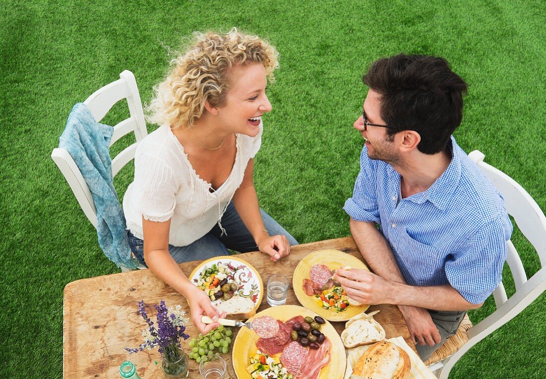 A couple eating a rustic breakfast in a garden