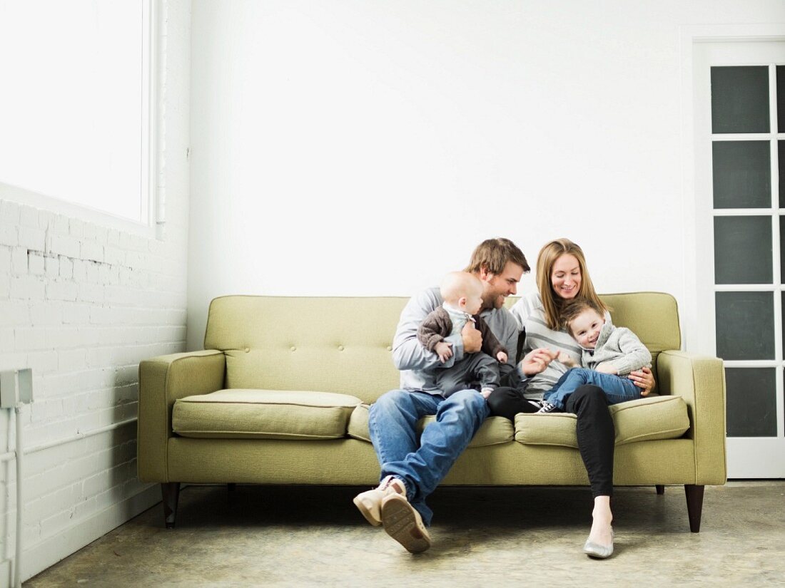 Family cuddling on sofa