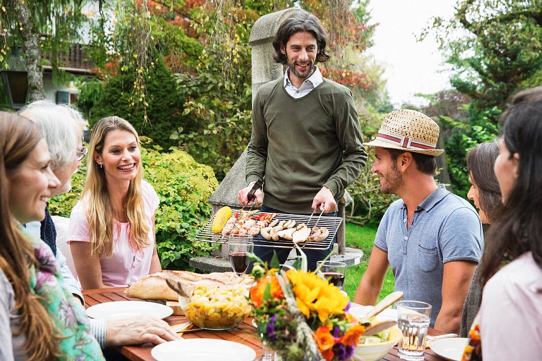 People having a barbecue in a garden