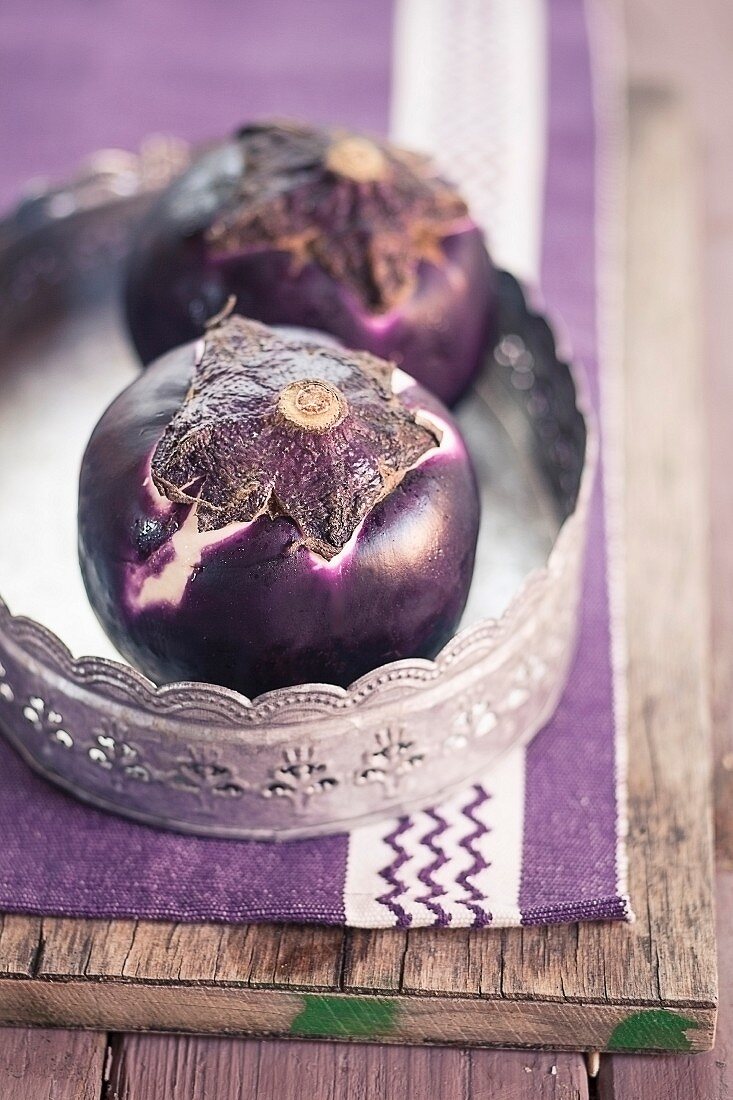 Two aubergines on a tray