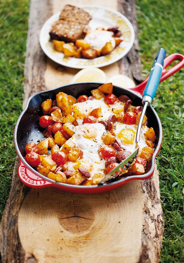 Fried potatoes with chorizo, tomatoes and fried egg