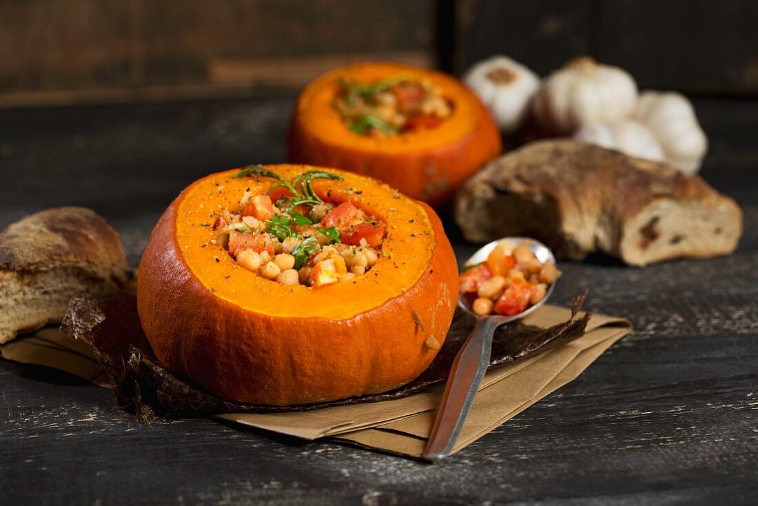 Baked Hokkaido pumpkins filled with beans, tomatoes and spices