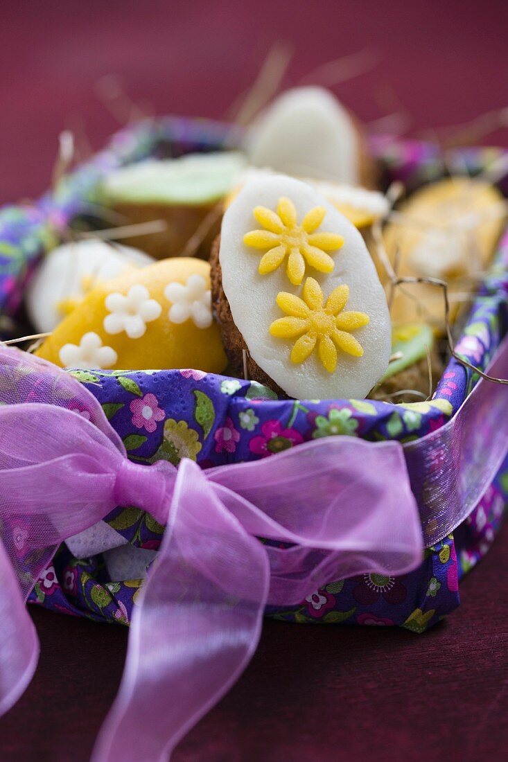 Mini marzipan pancakes in an Easter basket (close-up)