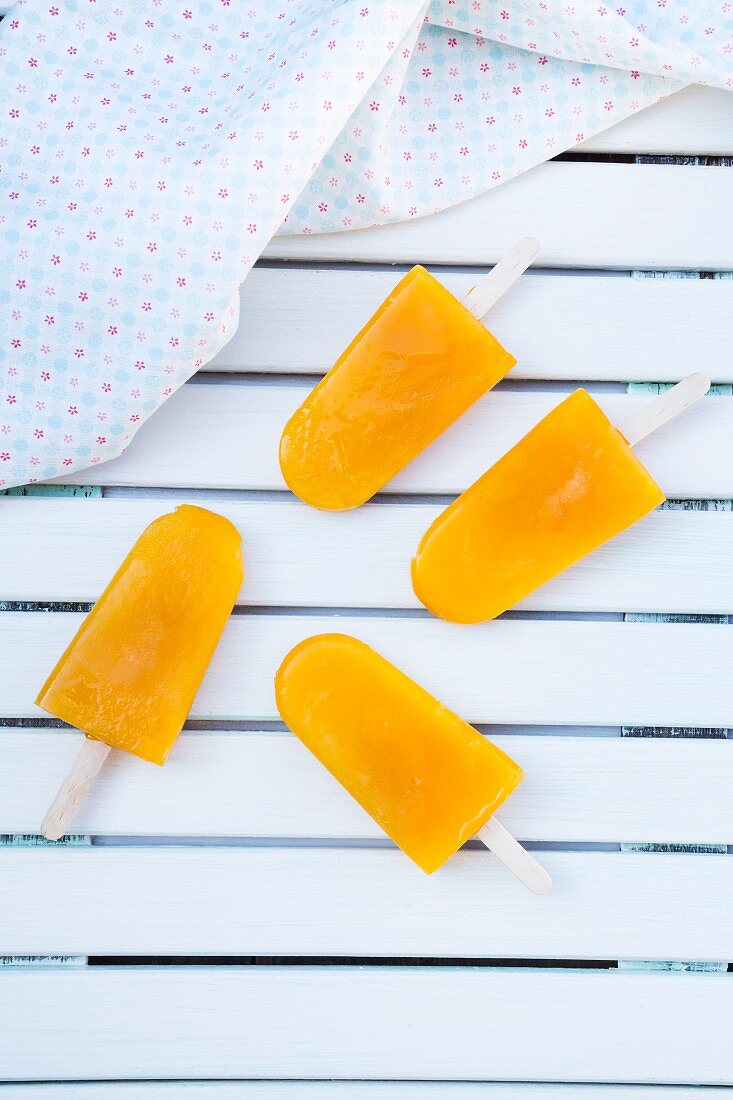 Four apple and mango ice lollies