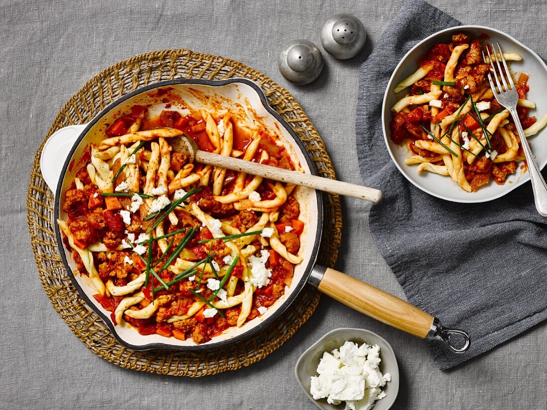 Pasta with tomato sauce, spicy sausage and feta cheese