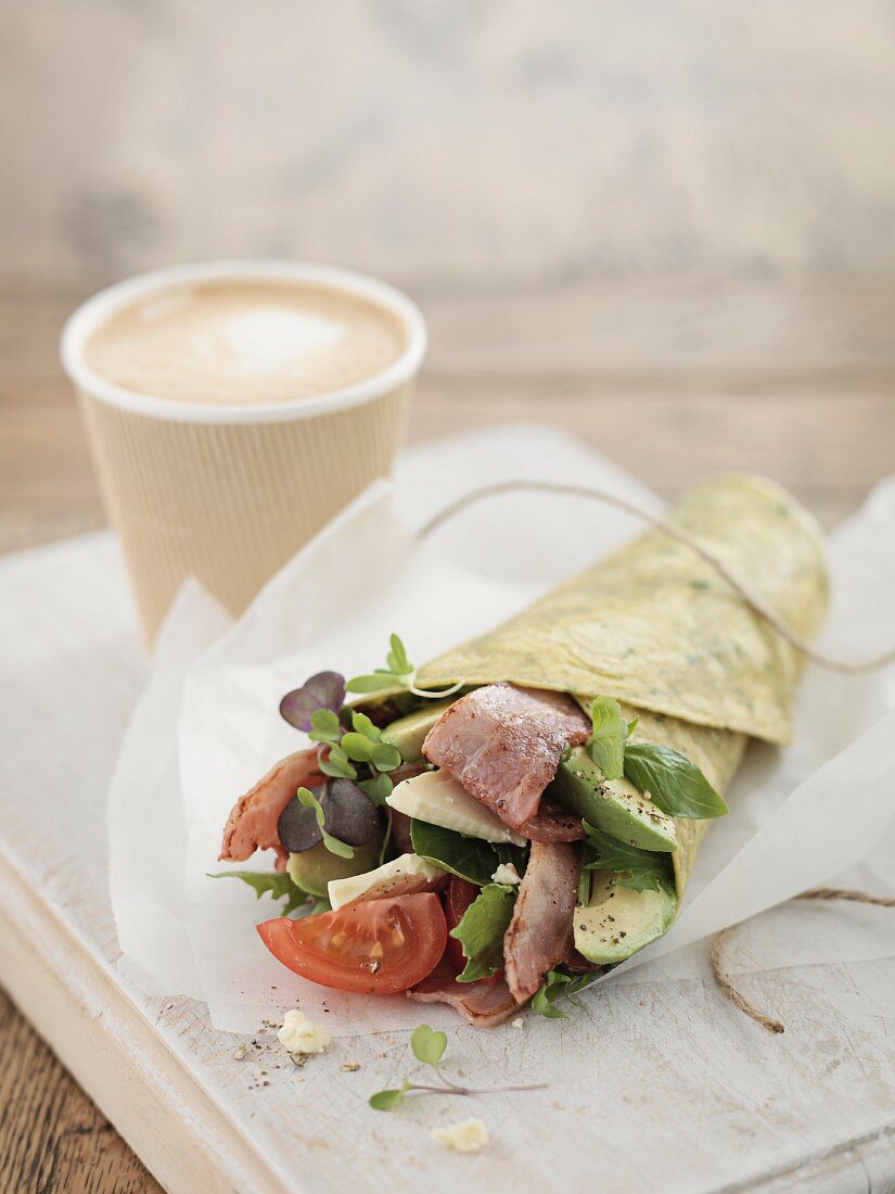 A salad and bacon wrap served with coffee