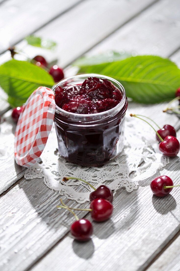 A jar of cherry jam and sour cherries