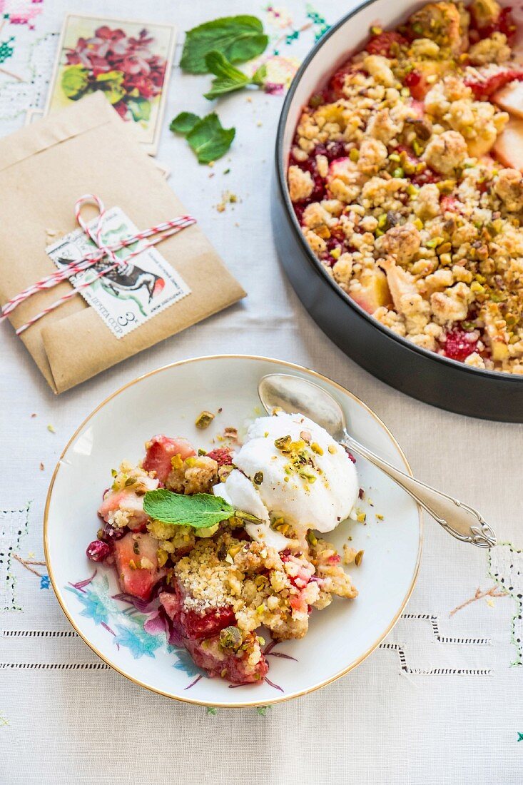 Apple and strawberry crumble on a plate and in a baking tin