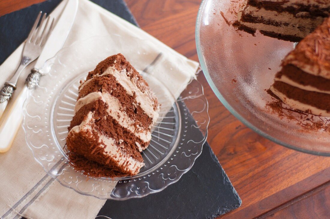 Mocha cake with grated chocolate on a glass plate